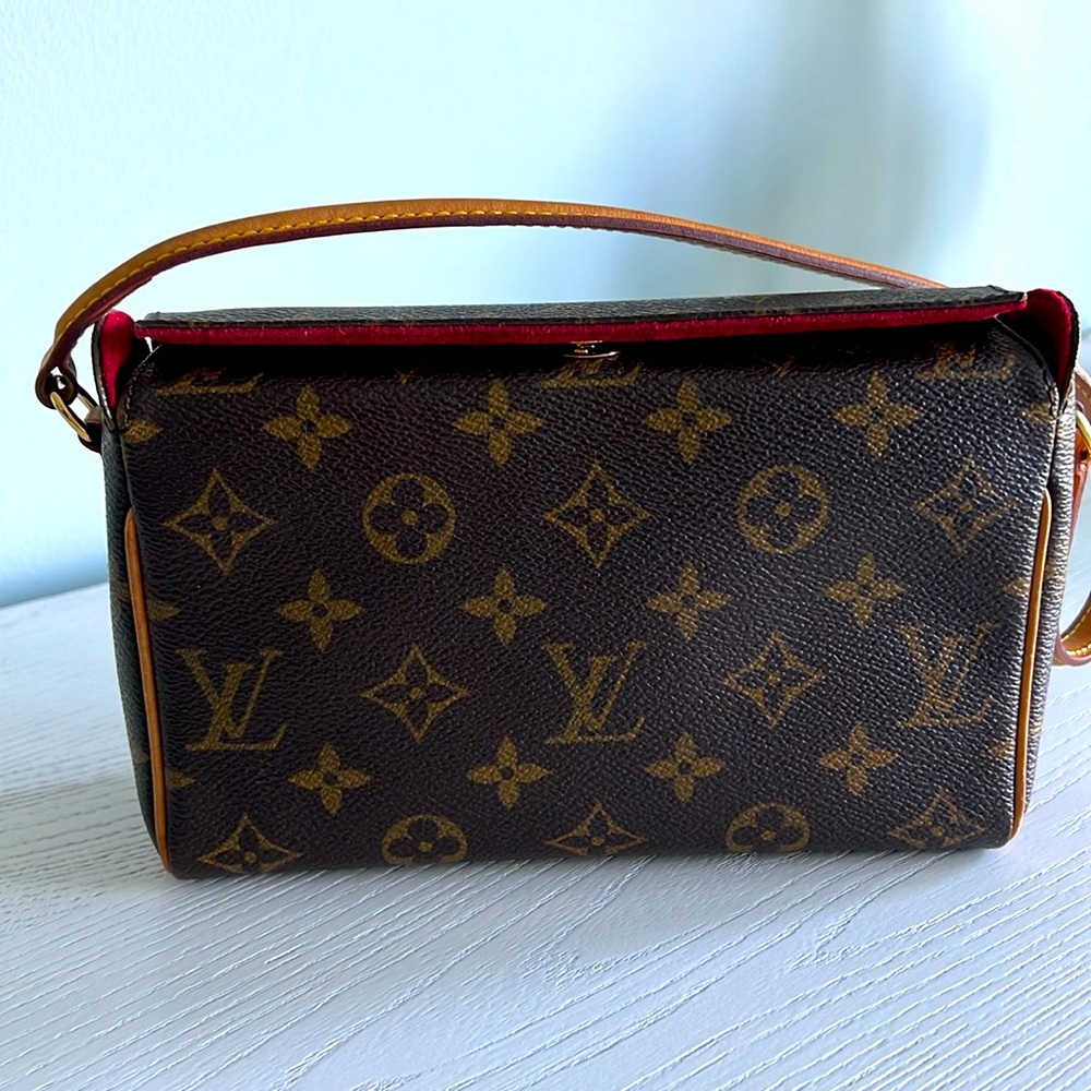 Original Louis Vuitton mini shoulder bag with red velvet interior.